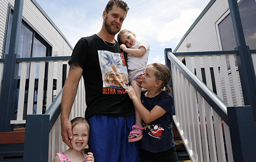 A photo of Jaquob Wilcox with his daughters