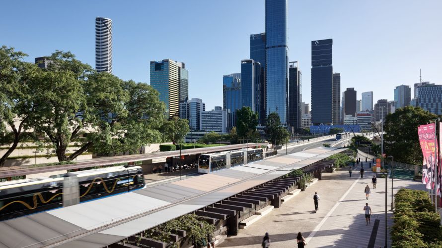 Birdseye view of the Brisbane Metro bus platform at the Cultural Centre, South Brisbane, from the overpass with the city buildings in the background.