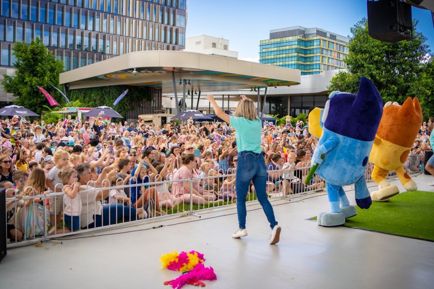 A crowd of people and an entertainer on stage